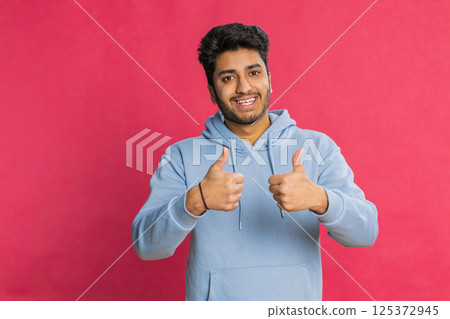 Indian man raises thumbs up agrees or gives positive reply recommends advertisement likes good idea 125372945