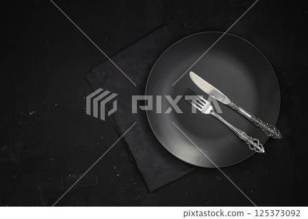 Empty black slate plate on stone table. Flatlay, top view. Mockup for restaurant dish Empty black slate plate on stone table. Flatlay, top view. Mockup for restaurant dish 125373092