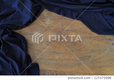 Top view, close-up of blue fabric or napkin on wooden table background. Concept kitchen 125373096