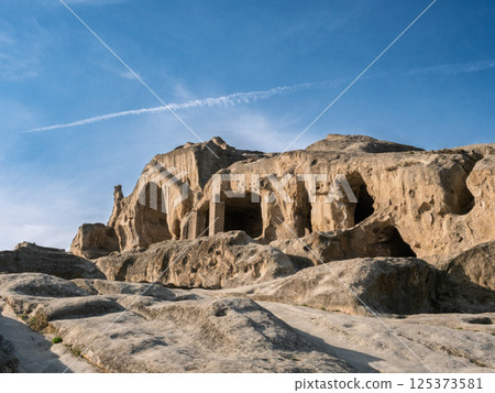 Uplistsikhe, an ancient rock hewn town in georgia, displays intricate cave dwellings carved into the cliff face Uplistsikhe, an ancient rock hewn town in georgia, displays intricate cave dwellings carved into the cliff face 125373581