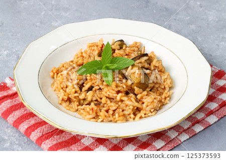 Turkish Stuffed Rice with Currants for Preparing Dolma in Plate with Spoon . Pilav or Pilaf 125373593