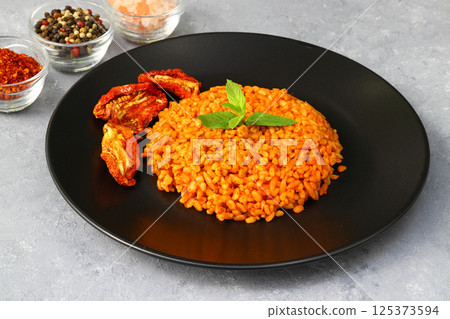 Traditional turkish bulgur pilaf with tomato sause in plate (Turkish name; meyhane pilavi) Traditional turkish bulgur pilaf with tomato sause in plate (Turkish name; meyhane pilavi) 125373594