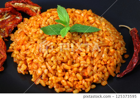 Traditional turkish bulgur pilaf with tomato sause in plate (Turkish name; meyhane pilavi) Traditional turkish bulgur pilaf with tomato sause in plate (Turkish name; meyhane pilavi) 125373595