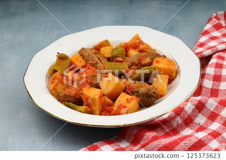 Traditional Homemade Turkish Food Kofte - Kofta with Tomato Sauce and Potatoes. (Turkish name; Izmir kofte) Traditional Homemade Turkish Food Kofte - Kofta with Tomato Sauce and Potatoes. (Turkish name; Izmir kofte) 125373623
