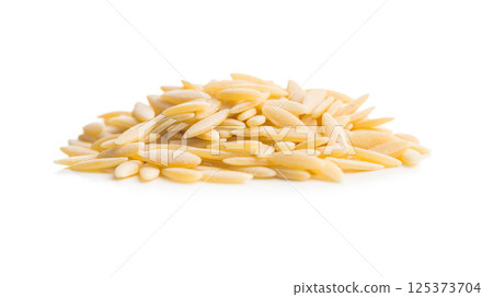 Orzo, kritharaki, risoni pasta. Uncooked dry pasta isolated on white background. Orzo, kritharaki, risoni pasta. Uncooked dry pasta isolated on white background. 125373704