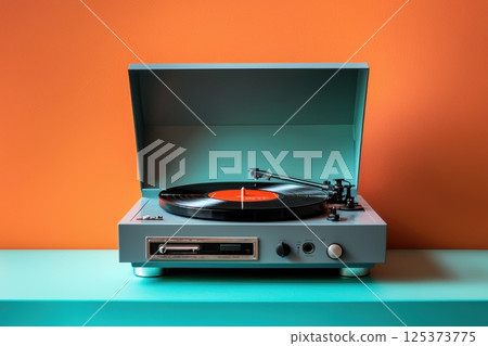 Retro vinyl record player in bold contrasting orange and blue setting 125373775