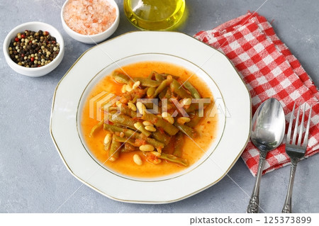 Homemade stewed green beans, tomatoes, garlic with olive oil. Zeytinyagli fasulye traditional food Homemade stewed green beans, tomatoes, garlic with olive oil. Zeytinyagli fasulye traditional food 125373899
