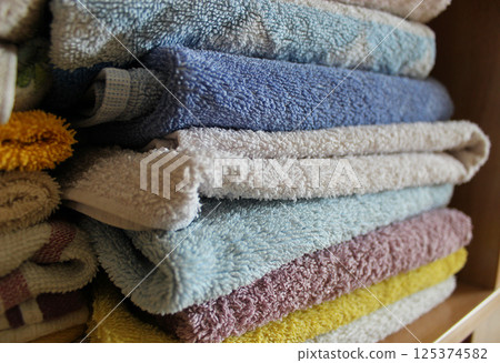 Home Wardrobe Shelf With Folded Clean Terry Towels On It  125374582