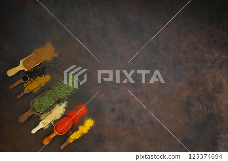 Photo different kind of spices on a wood background big set of indian spices on wooden table Photo different kind of spices on a wood background big set of indian spices on wooden table 125374694