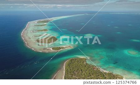 Stunning aerial perspective showcases a series of small tropical islands surrounded by vibrant turquoise waters. The scene reflects the beauty of unspoiled nature along the coastline during daylight. Stunning aerial perspective showcases a series of small tropical islands surrounded by vibrant turquoise waters. The scene reflects the beauty of unspoiled nature along the coastline during daylight. 125374766