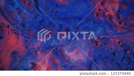Glitter ink. Defocused fluid flow. Beautiful blue red color liquid paint transparent bubbles motion on blurred bokeh light modern background. Glitter ink. Defocused fluid flow. Beautiful blue red color liquid paint transparent bubbles motion on blurred bokeh light modern background. 125374840
