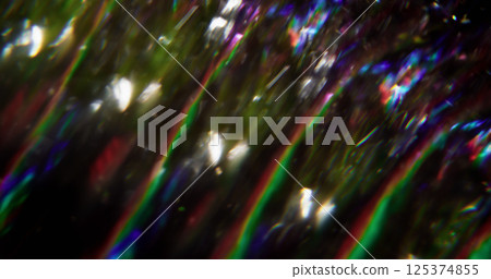 Glaring flow. Defocused luminous lines. Blue red green color flicker lens flare blurred beam motion on abstract bokeh light dark black background. 125374855