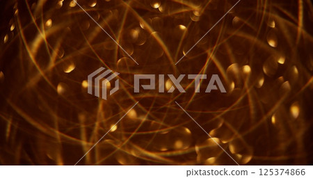 Defocused glittering garland. Bokeh light. Golden celebrate sparkling beautiful yellow colorful flickering circles motion on abstract blurred modern background. Defocused glittering garland. Bokeh light. Golden celebrate sparkling beautiful yellow colorful flickering circles motion on abstract blurred modern background. 125374866