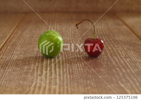Single whole fresh green Can Erik plum and cherry close up isolated on dark background 125375106