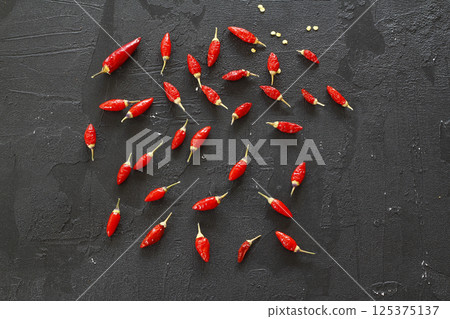 red hot chili peppers on black background red hot chili peppers on black background 125375137
