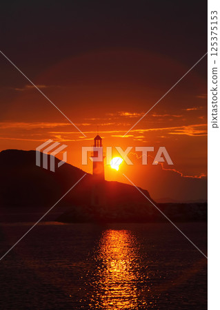 Seascape at sunshine. Lighthouse and sailings on the coast. Seaside town of Turgutreis and spectacular sunshine 125375153