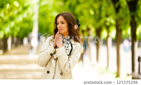 Elegant woman walking in green Paris park Elegant woman walking in green Paris park 125375298