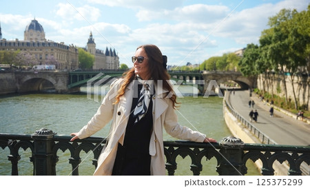 Woman on Paris bridge over the Seine River 125375299