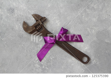 Craft gift with old tool on black background. Fathers-Labor day concept. Flat lay. Spanner gift. Craft gift with old tool on black background. Fathers-Labor day concept. Flat lay. Spanner gift. 125375390