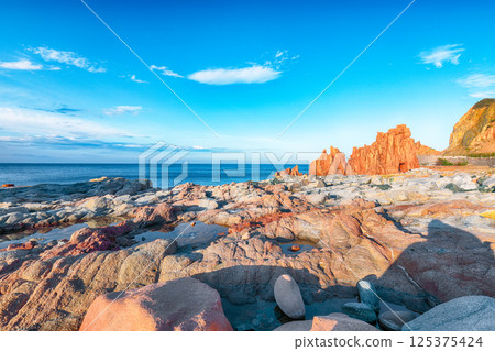 Exciting  sunset view of Red Rocks (Rocce Rosse) in Arbatax. 125375424