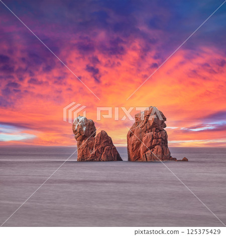 Remarkable sunset view of Red Rocks (is Scoglius Arrubius) on Cea beach 125375429