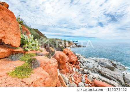 Exciting  sunset view of Red Rocks (is Scoglius Arrubius) on Cea beach. 125375432
