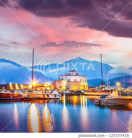 Exciting sunset view on boats in beautiful marina of Villasimius. 125375438
