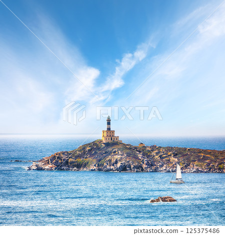 Marvelous view of Capo Carbonara lighthouse with turquoise water Marvelous view of Capo Carbonara lighthouse with turquoise water 125375486