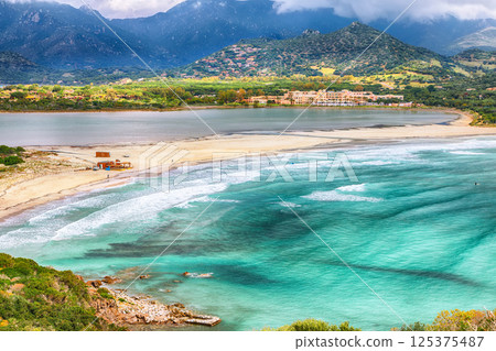Astonishing view on Lagoon of Porto Giunco with turquoise water and old tower. Astonishing view on Lagoon of Porto Giunco with turquoise water and old tower. 125375487