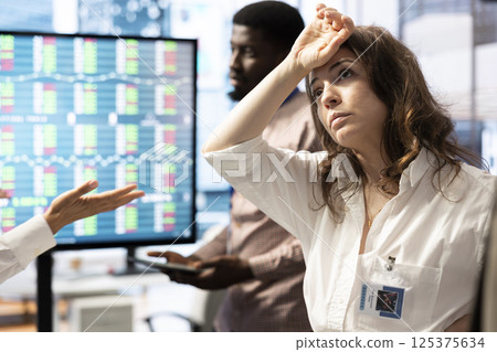 Angry CEO in tension trying to manage an organizational crisis in a boardroom, working under pressure before project deadline. Female manager feeling frustrated and dissatisfied at work. Angry CEO in tension trying to manage an organizational crisis in a boardroom, working under pressure before project deadline. Female manager feeling frustrated and dissatisfied at work. 125375634