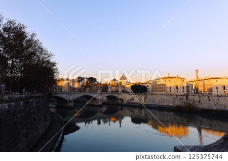 Rome in morning. Panoramic view of Castel Sant'Angelo and Bridge in Rome with reflection in Tiber river. 125375744