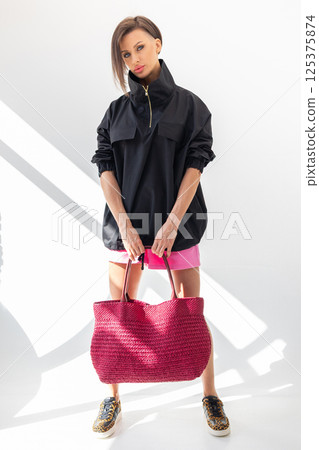 Beautiful woman holding fashionable red woven bag. Fashion and luxury accessories. Vertical photo. High quality photo Beautiful woman holding fashionable red woven bag. Fashion and luxury accessories. Vertical photo. High quality photo 125375874