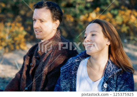 Portrait happy beautiful couple in love enjoying autumn picnic in autumn park. High quality photo 125375925