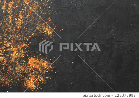 Pile crushed red cayenne pepper, dried chili flakes and seeds on black background. 125375992