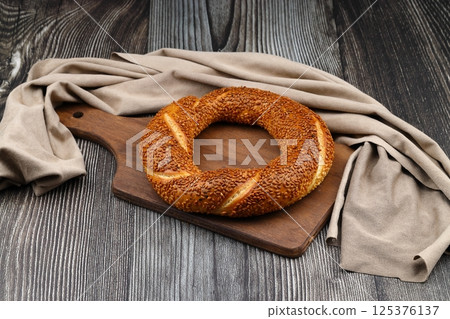 Turkish traditional bagel / simit with sesame on rustic table, turkish breakfast pastry concept 125376137