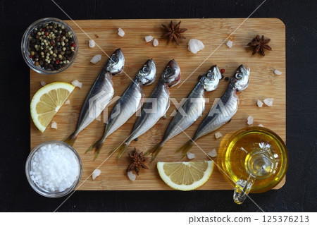Fresh fish horse mackerel on a dark background Fresh fish horse mackerel on a dark background 125376213