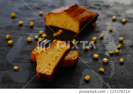 corn bread with knife on black background. with fresh corn. corn bread with knife on black background. with fresh corn. 125376214