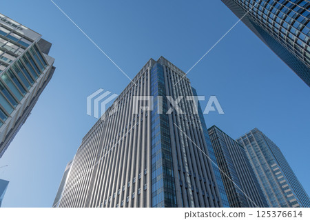 Skyscrapers towering over the blue sky 125376614