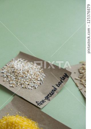 Raw fine ground barley porridge with text in paper. Refill product format eco-friendly living. Filling reusable container Whole spelt grain species. High protein fiber-rich vegan plant based food Raw fine ground barley porridge with text in paper. Refill product format eco-friendly living. Filling reusable container Whole spelt grain species. High protein fiber-rich vegan plant based food 125376879