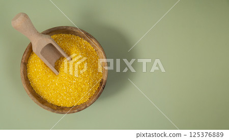 Corn porridge in green background copy space Whole spelt grain species. High protein fiber-rich vegan plant based food ingredient. Gluten free superfood healthy nutritional dietary alternative 125376889