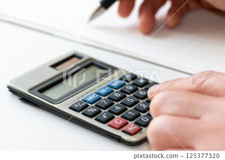 Do calculations using a calculator Do calculations using a calculator 125377320