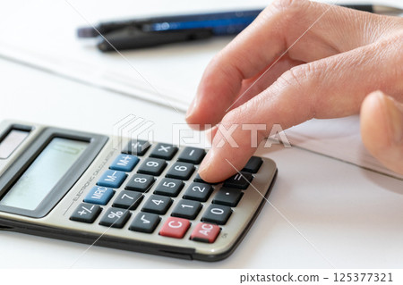 tapping on a calculator tapping on a calculator 125377321