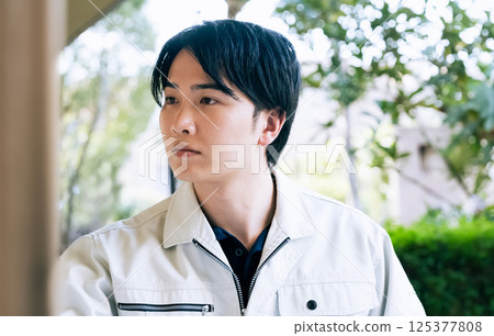 A man in work clothes working outdoors 125377808