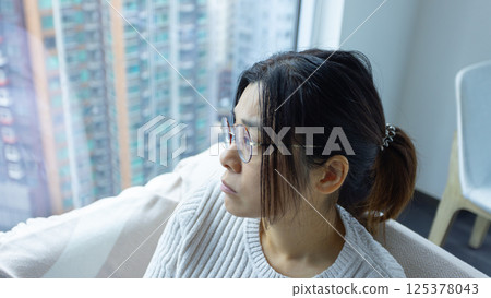 woman look up and feel stress at home, wearing the glasses 125378043