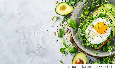 Avocado toast served on a rustic ceramic plate, topped with a poached egg and fresh microgreens. Styled on a bright, minimal background with upper space for a headline perfect for health AI generated 125378121