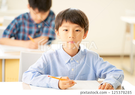 Elementary school student staring straight ahead 125378285