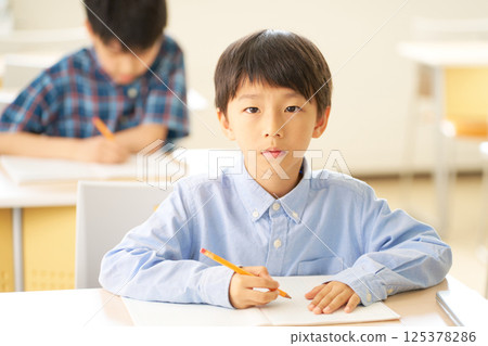 Elementary school student staring straight ahead Elementary school student staring straight ahead 125378286
