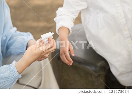 Image of insect repellent spray outdoors, close-up without face 125378624