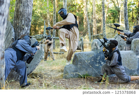 Skillful paintball team attacking hostile positions 125378868