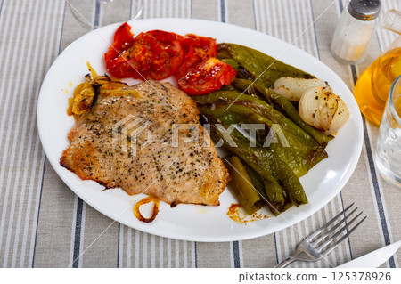 Secreto de cerdo - roasted pork served with stewed pepper and tomatoes Secreto de cerdo - roasted pork served with stewed pepper and tomatoes 125378926